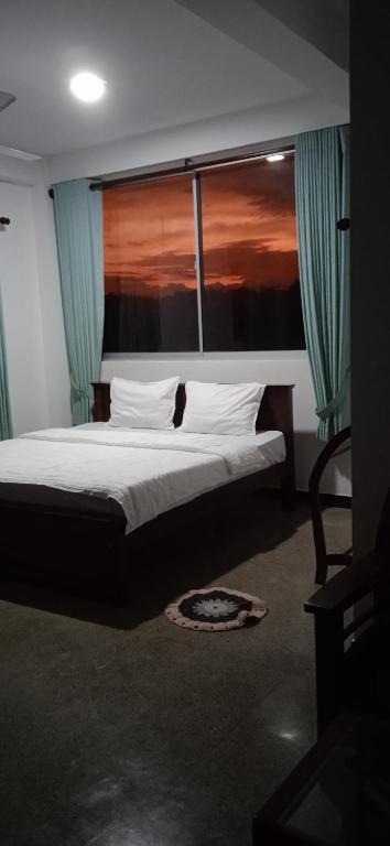 Double bed with sunset view through window